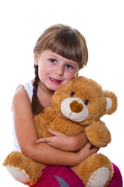 adorable toddler girl hugging a teddy bear