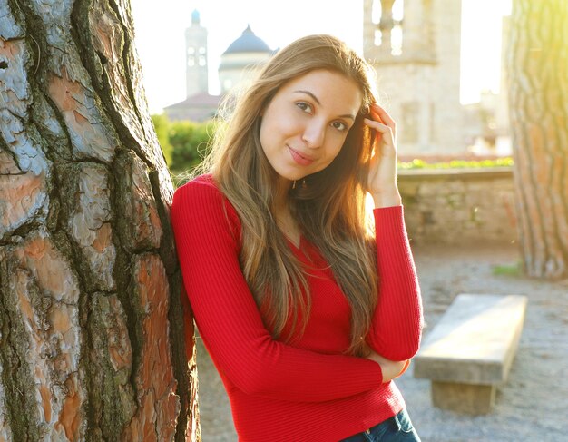 Adorable woman near tree outdoor