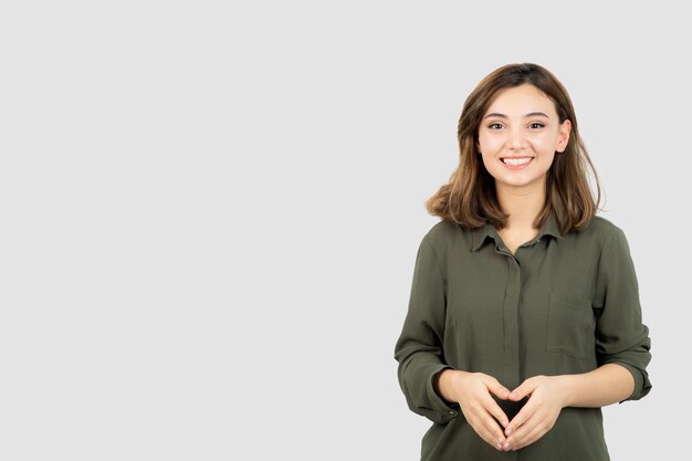 Adorable young woman in casual outfit standing and posing to camera