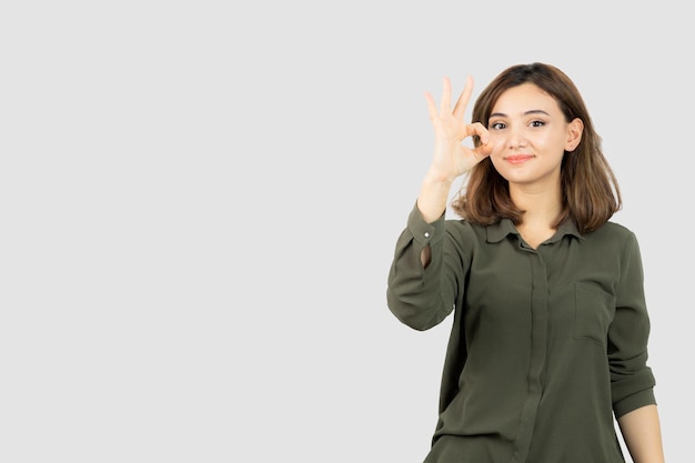 Adorable young woman in casual outfit standing and posing