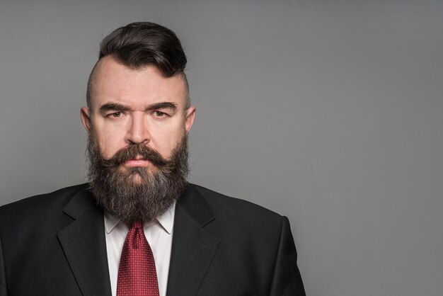 Adult angry bearded man in a suit Toned