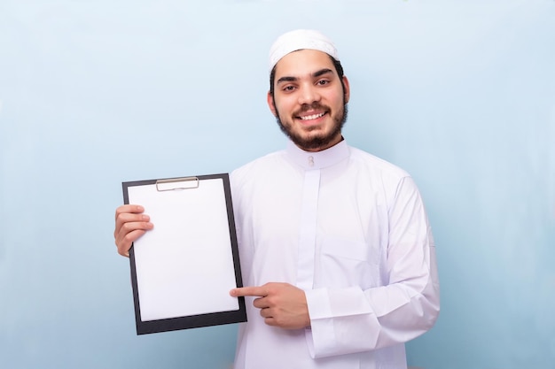 Adult arab man student posing standing holding form