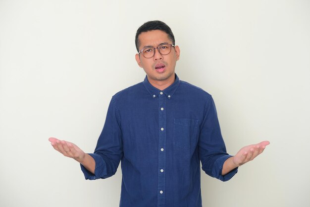 Adult Asian man looking to camera with confused expression