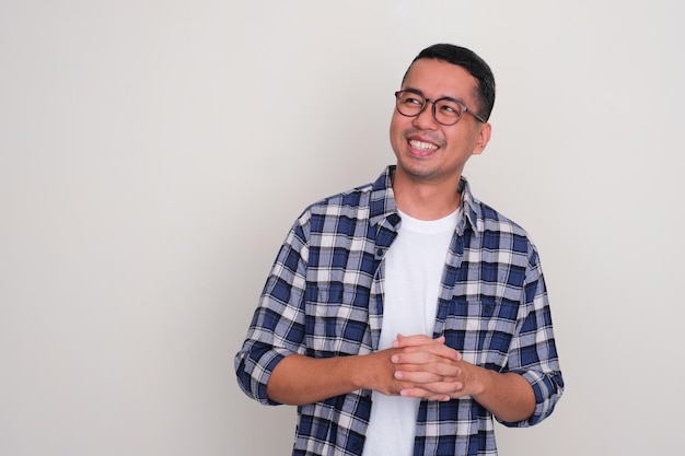 Adult Asian smiling proud while looking to the right side