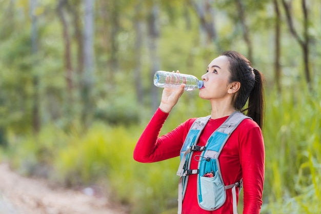 Premium Photo  Portrait adult asian woman trail runner with running vest  doing trail running training in the forest park