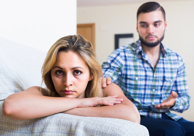 adult asking offended partner for forgiveness at home 