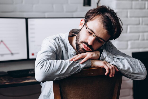 Adult bearded man working sitting at home desk at computer Selfisolation during quarantine work at home copy space