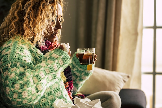 Adult beautiful caucasian woman at home sick with ill and cold drinking  hot tea 