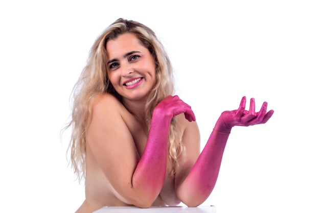 Adult blond young woman with painted pink hands  over a white.