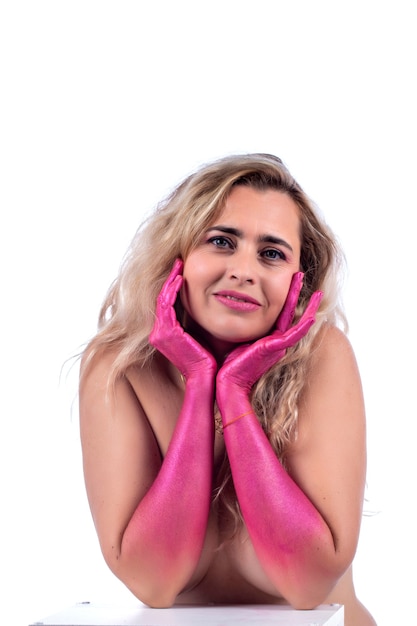 Adult blond young woman with painted pink hands  over a white.