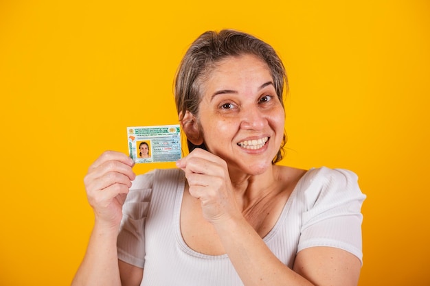 Adult Brazilian woman holding driver's license