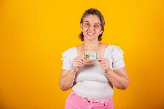 Adult brazilian woman holding identity card rg