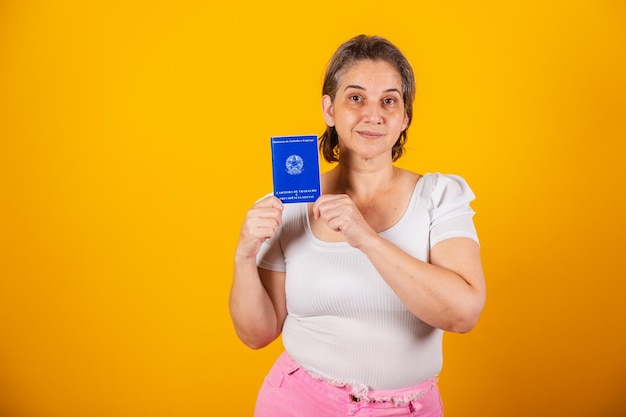 Adult Brazilian woman holding work and social security card Brazilian document for formal work