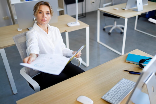 Adult business woman giving document