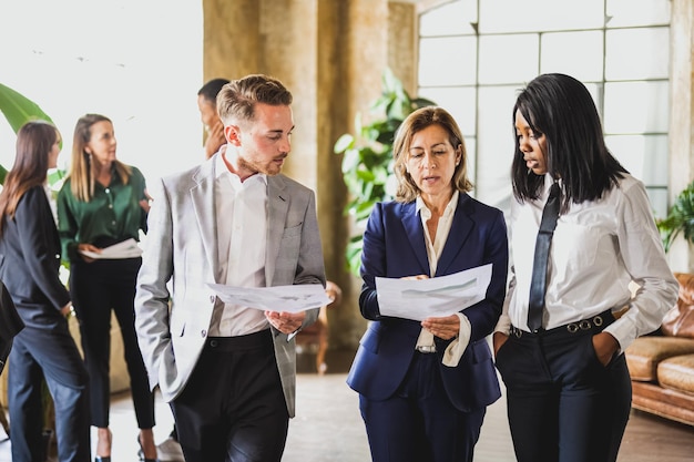 Adult businesswoman talking about financial report with her staff