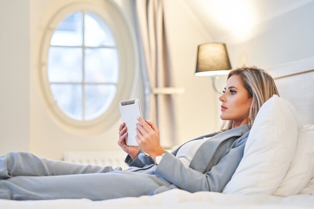 Adult businesswoman working on computer in hotel room