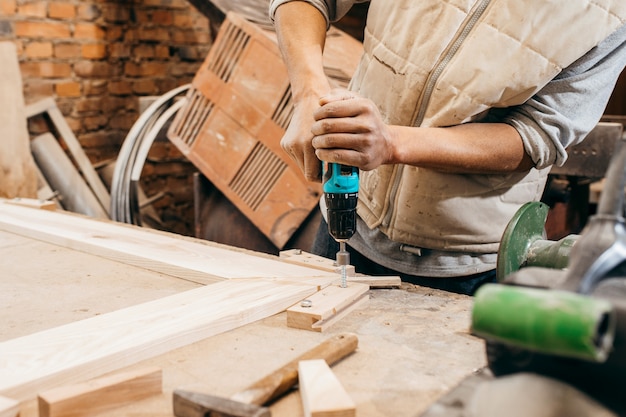 Adult carpenter working in his workshop