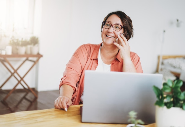 Adult charming brunette woman in glasses plus size body positive working with laptop at home office