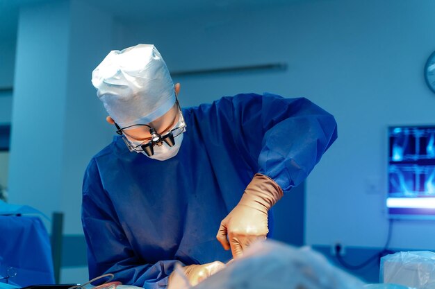 Adult concentrated doctor in uniform and mask doing work Operation in hospital