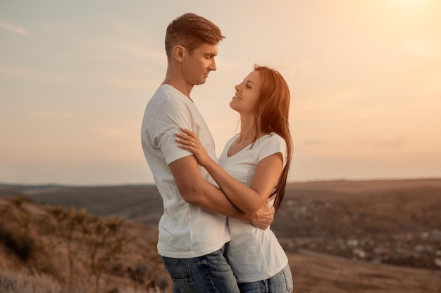 Adult couple embracing in countryside