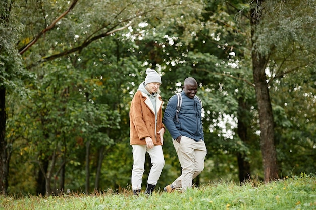 Adult couple enjoying walk in autumn forest