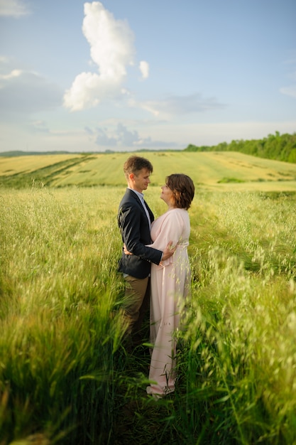 Adult couple in a green wheat field