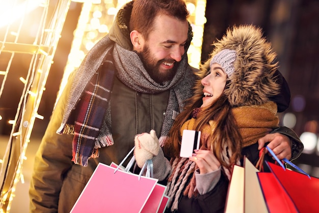 adult couple shopping in the city during Christmas time