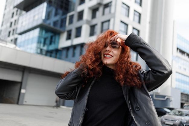 An adult female businesswoman in a big city Talking on a mobile phone and smiling