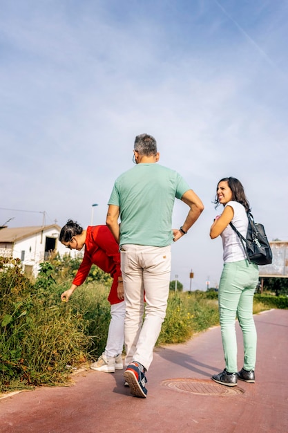 Adult friends walking carefree in public park