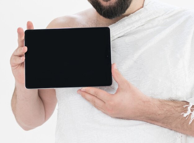 Adult Hajj holding tablet