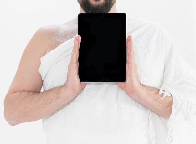 Adult Hajj holding tablet