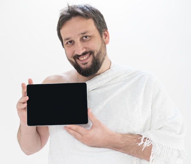 Adult Hajj holding tablet