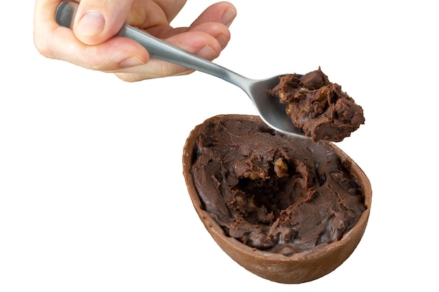 Adult hand scooping up chocolate easter egg filling with a spoon