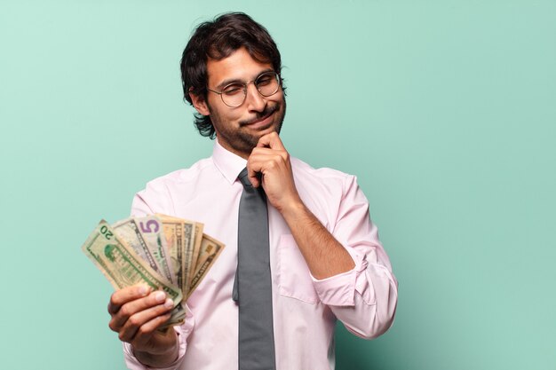 Adult handsome indian businessman with dollar banknotes