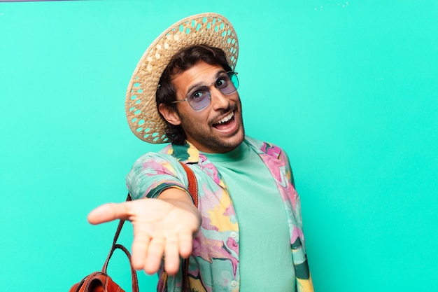 Adult handsome indian tourist man wearing hay and a leather bag