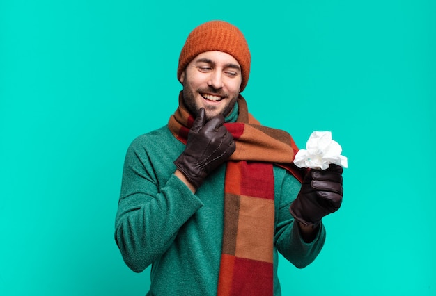 Adult handsome man smiling with a happy, confident expression with hand on chin