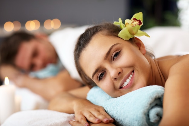 adult happy couple relaxing in spa salon