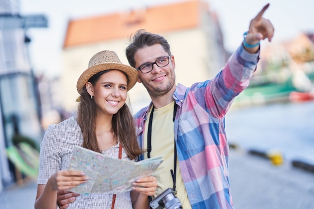 adult happy tourists sightseeing Gdansk Poland in summer