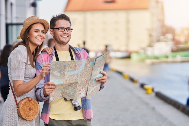 adult happy tourists sightseeing Gdansk Poland in summer