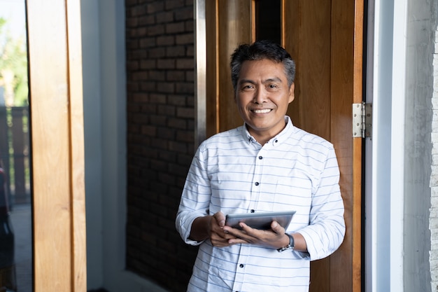 Adult indonesian man using a tablet