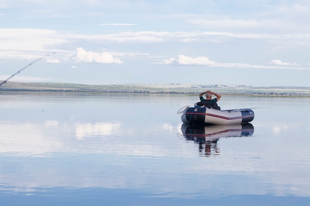 Adult male fisherman in a boat at daytime