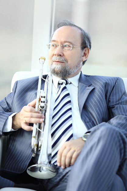 Adult male musician sitting in a chair