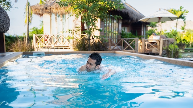 Adult male swimming in the pool