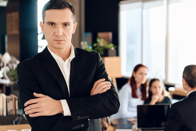 Adult man in black jacket stands in front of lawyer's office