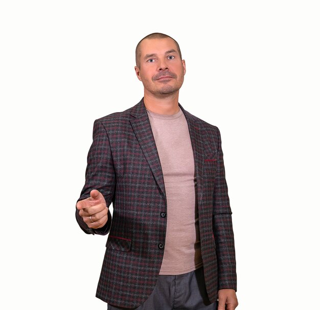 adult man dressed in a free style, points a finger at you, isolated on a white background