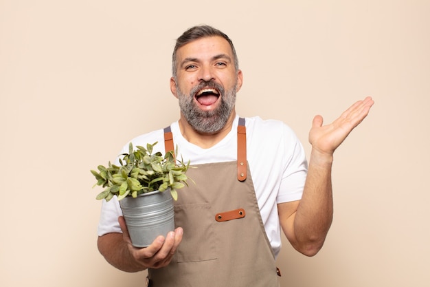 Adult man feeling happy, excited, surprised or shocked, smiling and astonished at something unbelievable