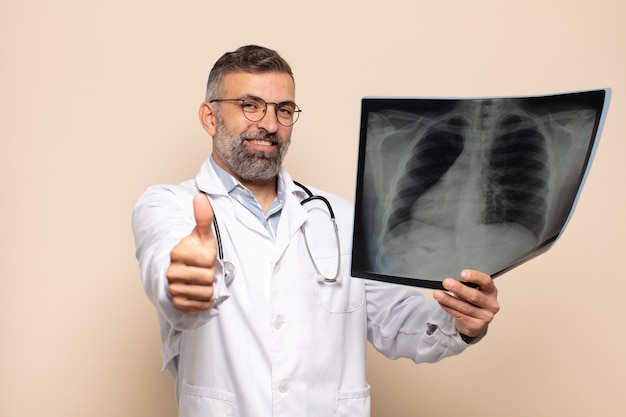 Adult man feeling proud, carefree, confident and happy, smiling positively with thumbs up