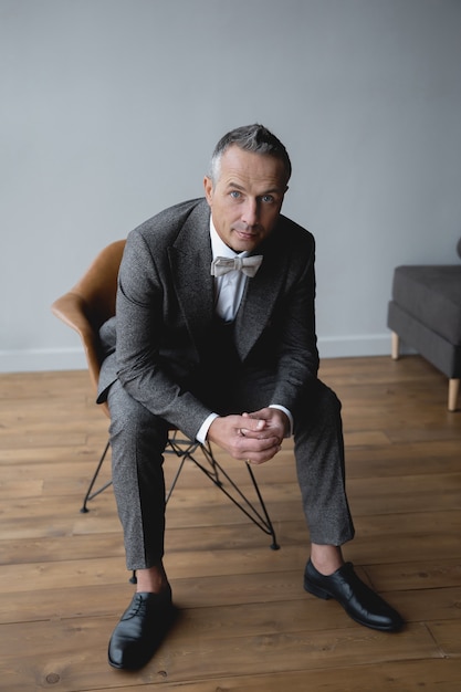 Adult man in a gray suit on wedding day