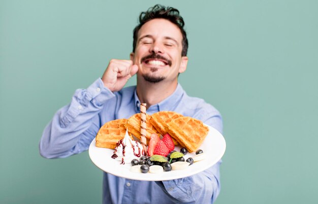 Photo adult man having waffles for breakfast