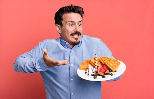 Photo adult man having waffles for breakfast